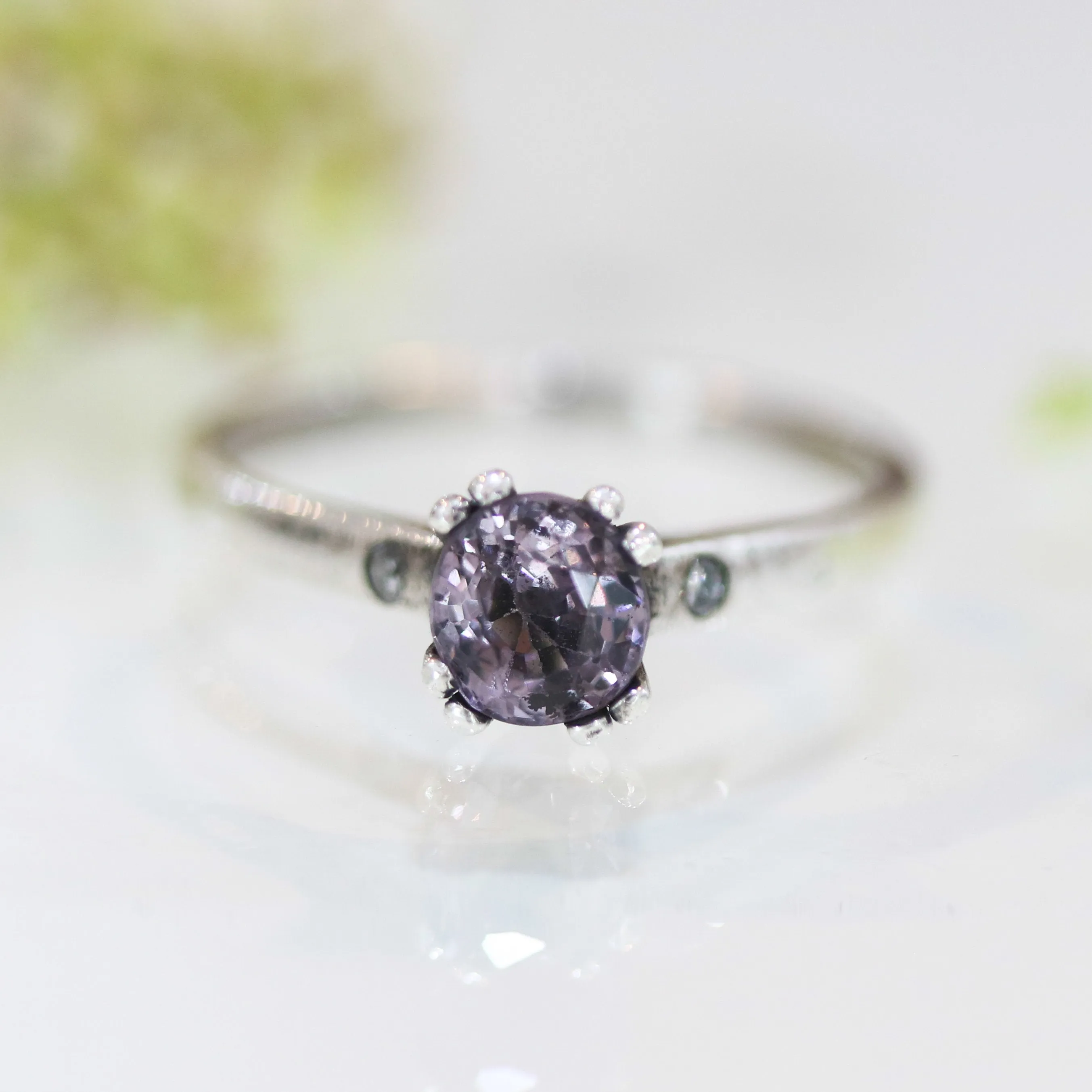Purple spinel ring in prongs setting and diamond side set with sterling silver band
