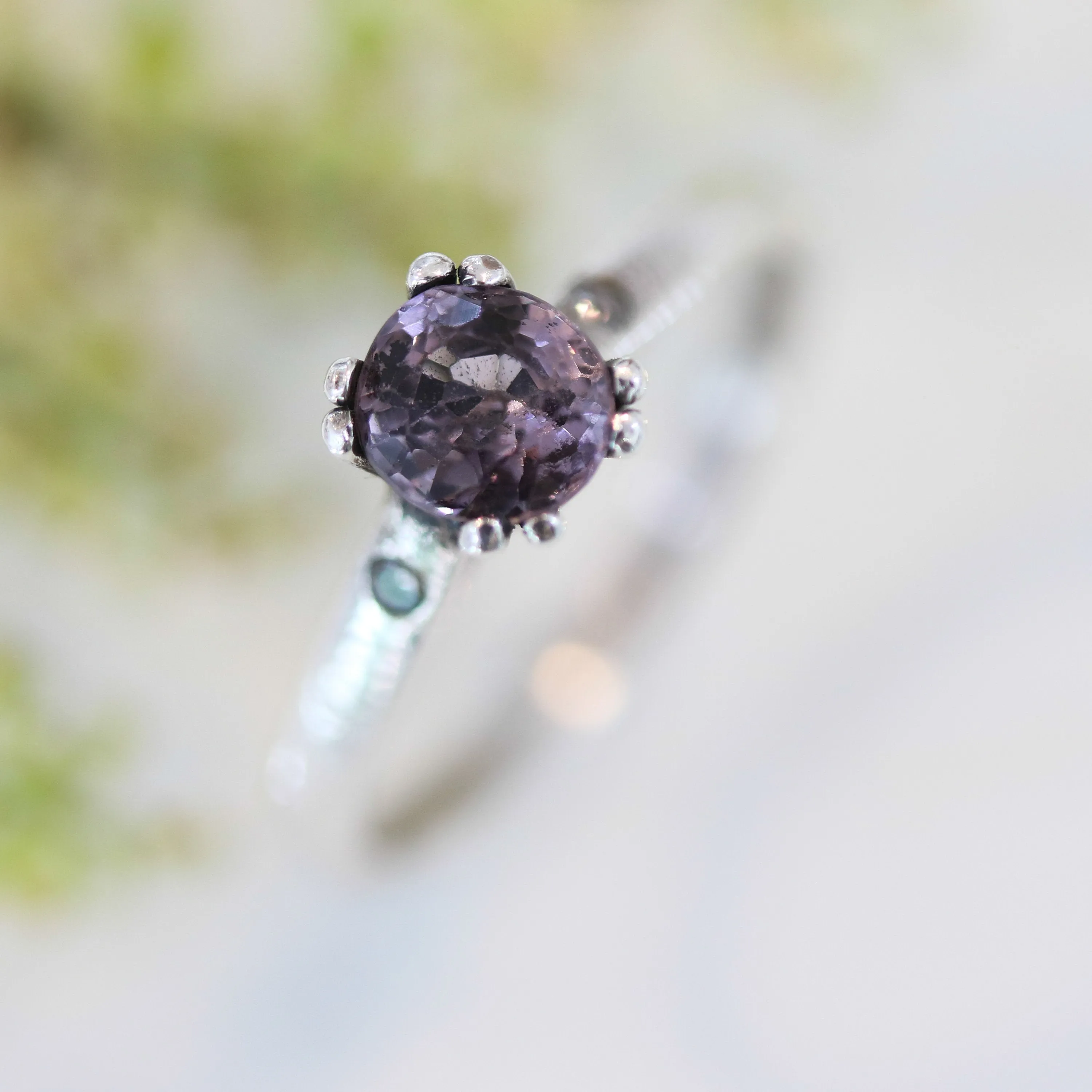 Purple spinel ring in prongs setting and diamond side set with sterling silver band