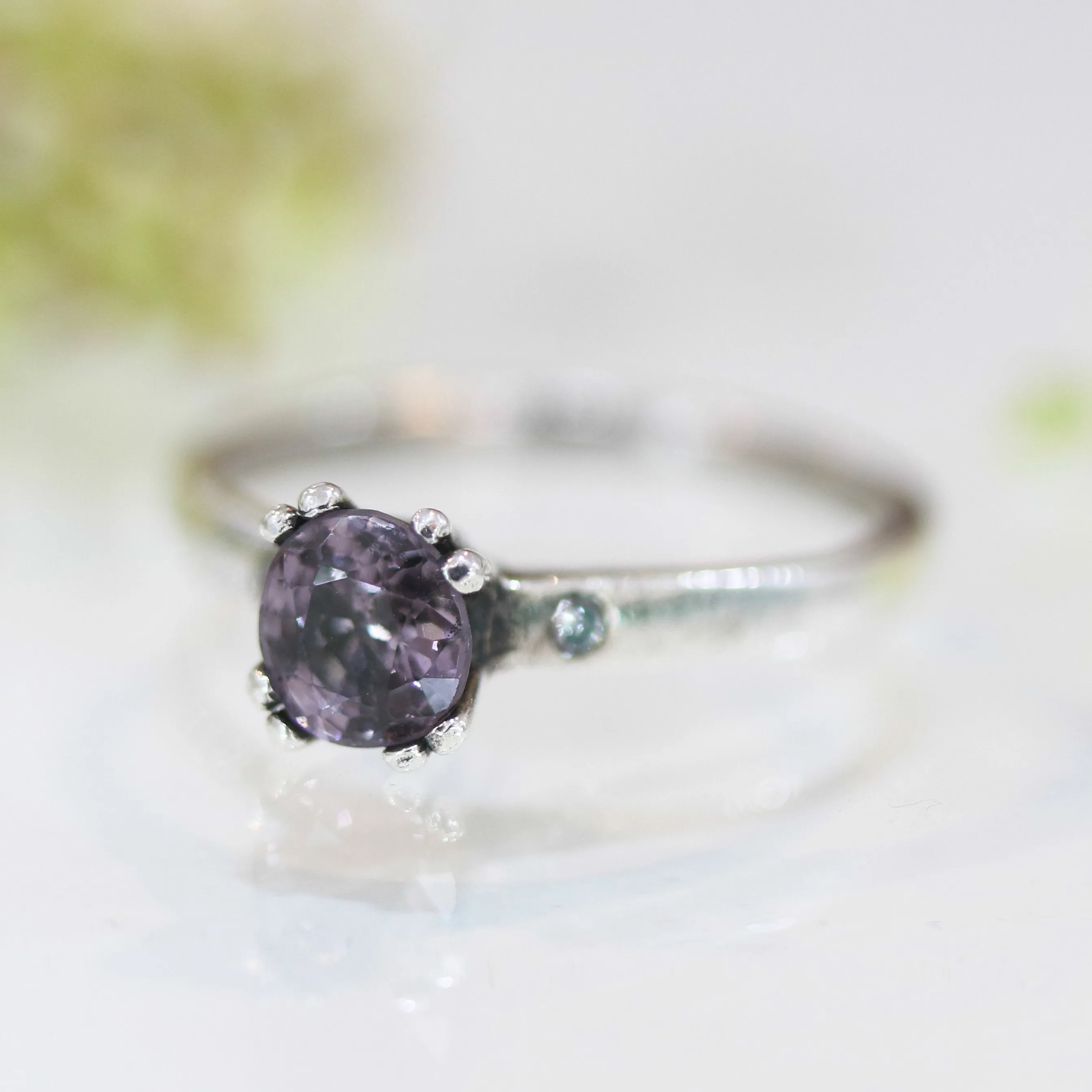 Purple spinel ring in prongs setting and diamond side set with sterling silver band