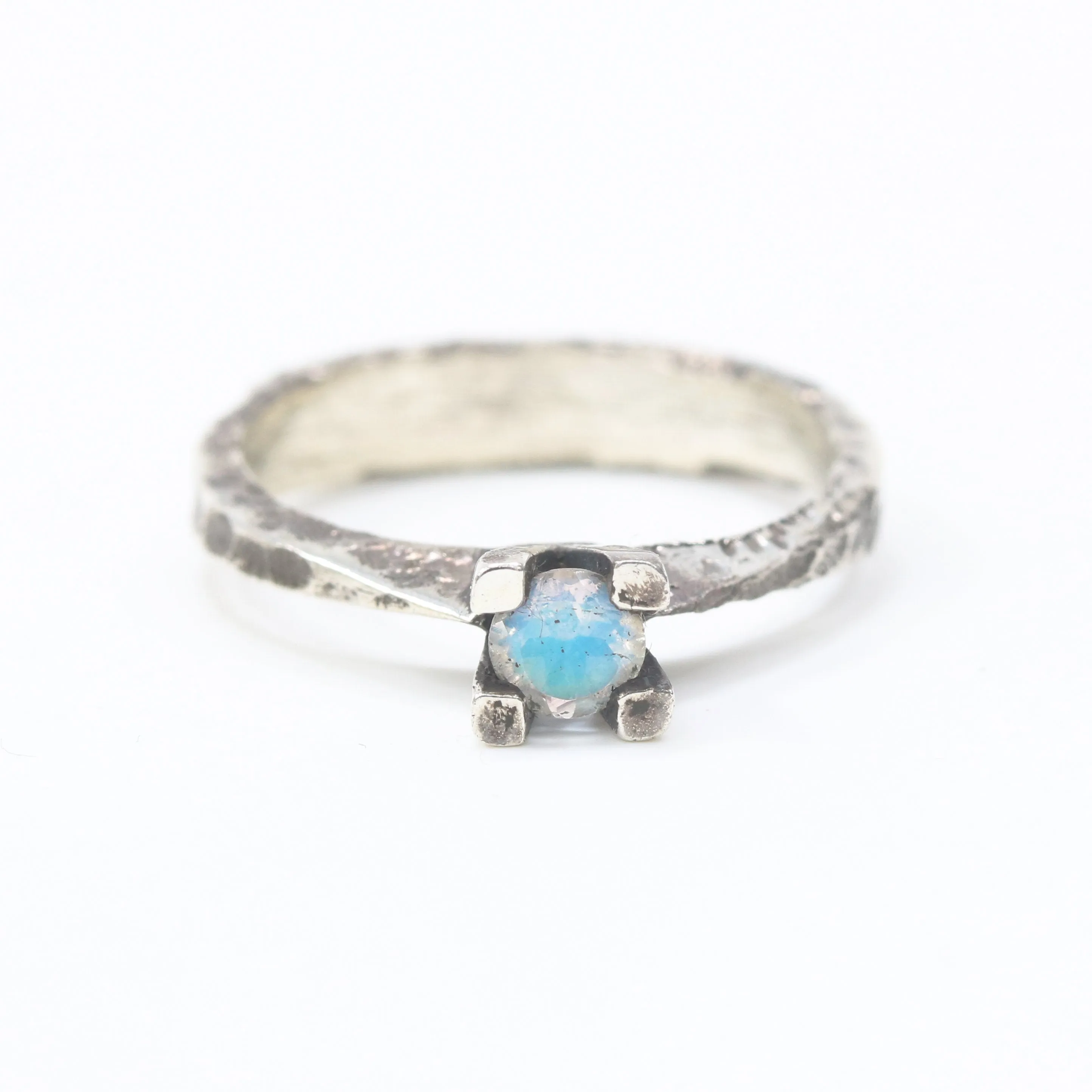 Tiny round faceted moonstone ring in silver prongs setting with sterling silver hard texture oxidized band