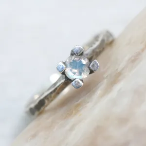 Tiny round faceted moonstone ring in silver prongs setting with sterling silver hard texture oxidized band